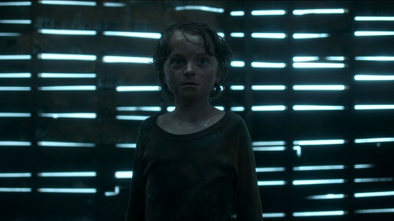 Tobin in In The Tall Grass, standing in a dilapidated barn