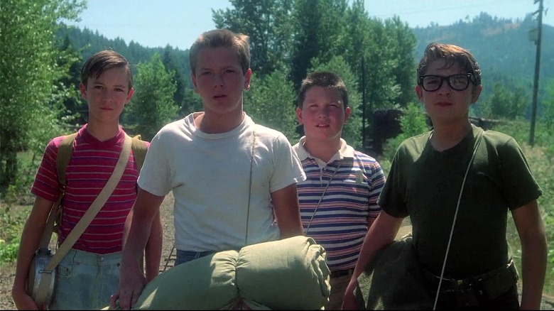 Gordie, Chris, Vern, and Teddy standing in front of the railroad tracks in 