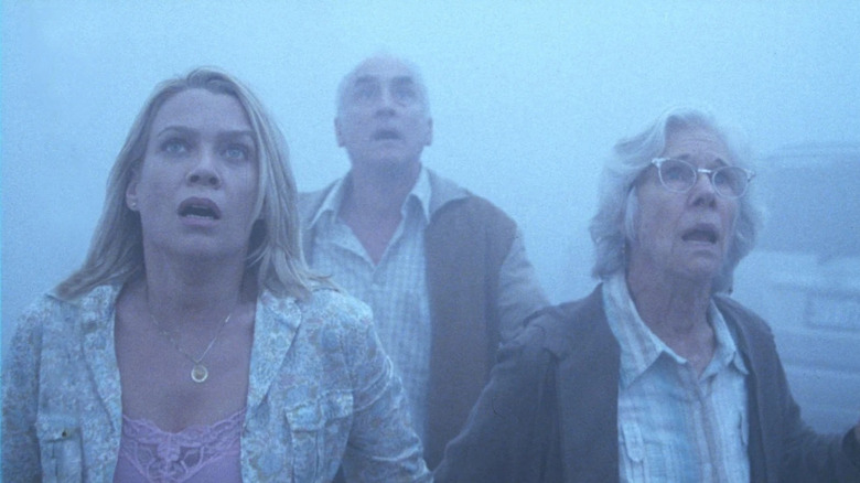 Amanda Dumfries, Dan Miller, and Irene Reppler staring up in horror in "The Mist"