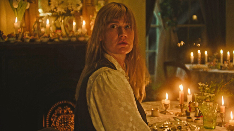 Diana sitting at a candlelit table in "Honey Bunch" (2025)