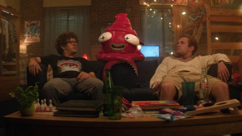 Jack and Montgomery looking at a squid on their couch in "Pizza Movie" (2026)