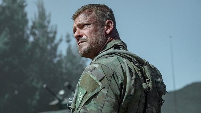 81 turns and looks up in "War Machine" (2026)