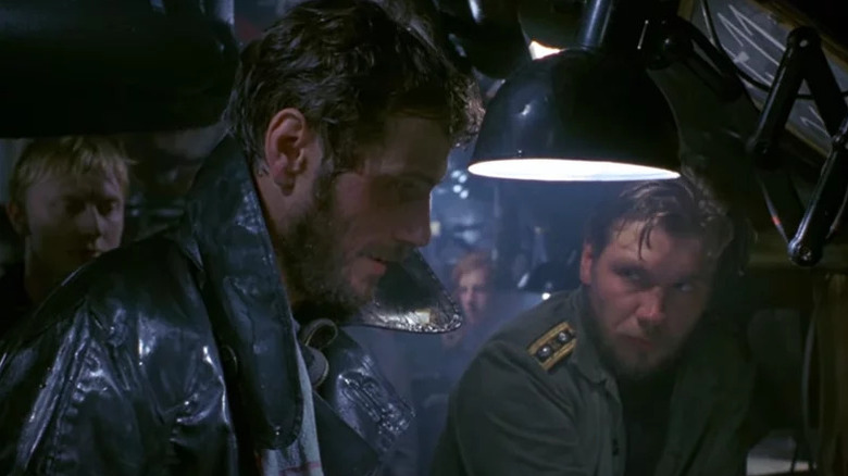 Der Alte looking thoughtful while his men are looking on in Das Boot