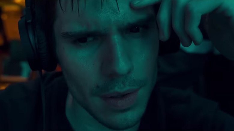 Chanteraide sweating and listening on his headphones in The Wolf's Call