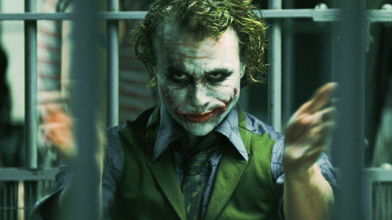 The Joker clapping in his jail cell in The Dark Knight (2008)