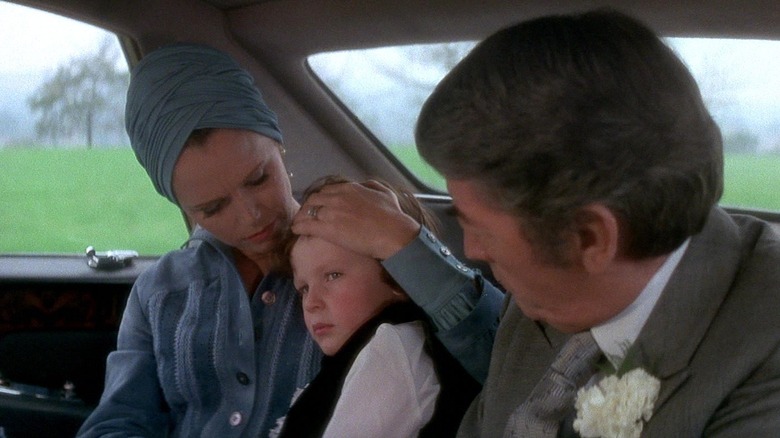 Katherine Thorn holding Damien in the car in "The Omen"