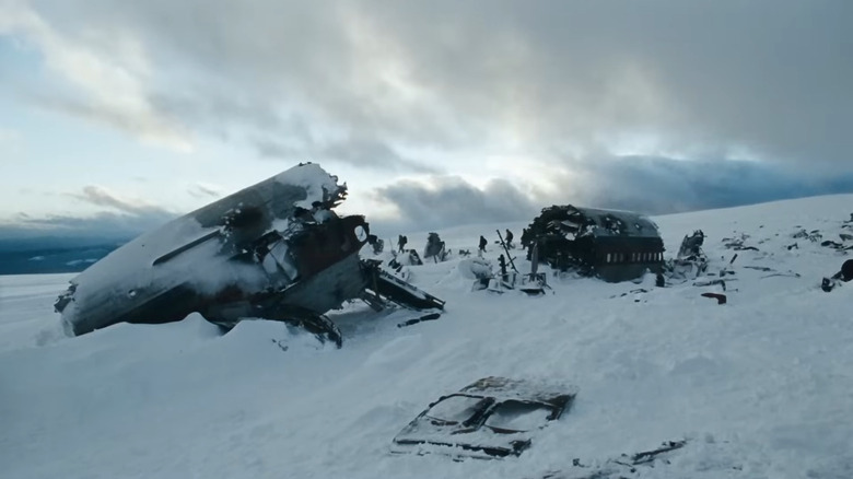 John Ottway walking through snow-covered wreckage in "The Grey" (2011)