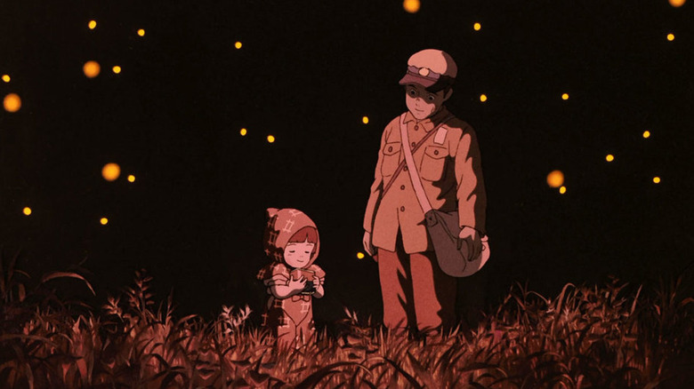 Seito and Setsuko walking through field with fireflies