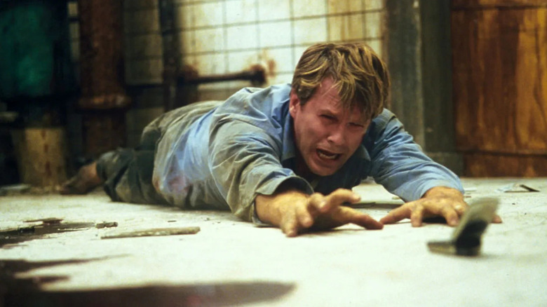 Dr. Lawrence Gordon crying and crawling in Saw