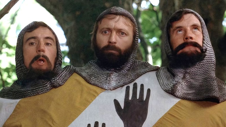 The Three-Headed Knight standing in front of trees in "Monty Python and the Holy Grail."