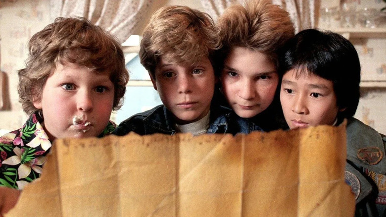 Chunk, Mikey, Mouth, and Data looking at the treasure map in "The Goonies."