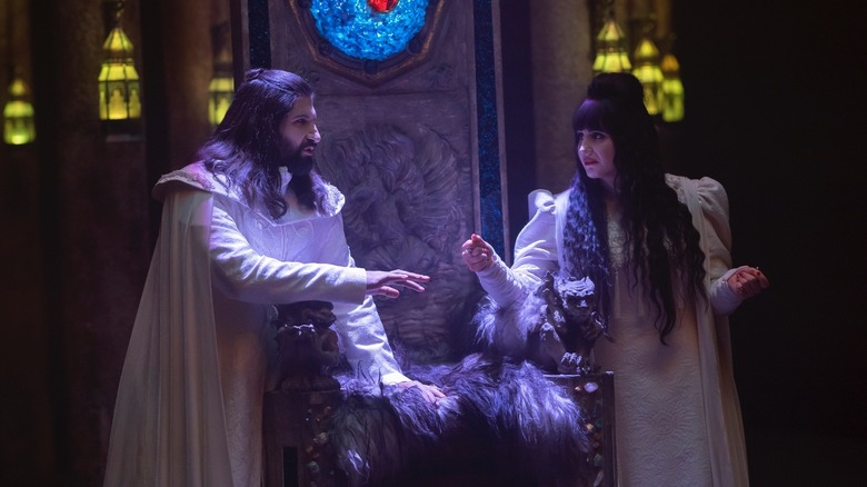 Nandor and Nadja leaning on a throne in What We Do in the Shadows (2019)