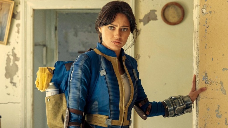 Lucy leaning on a wall in "Fallout" (2024-present)