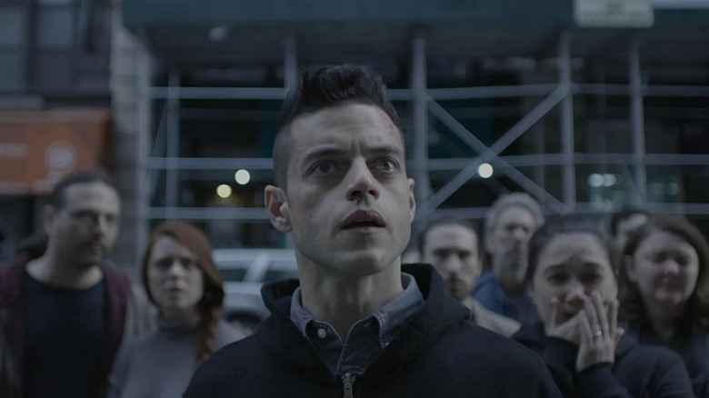 Alderson watches a news broadcast in shock in Mr. Robot