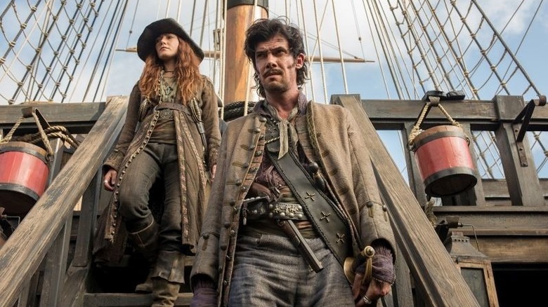 Jack and Eleanor walk down the steps on the ship in "Black Sails" (2014-2017)
