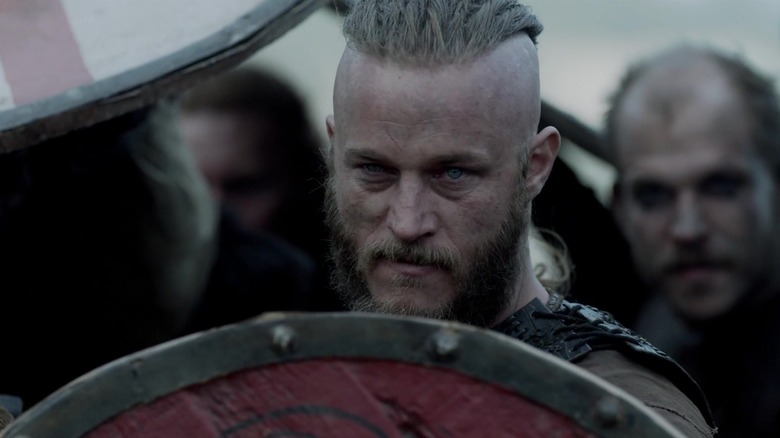 Lodbrok looks out from behind his shield in "Vikings" (2013-2020)