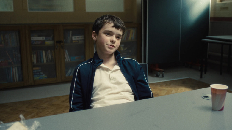 Jamie leaning back in his chair in Adolescence