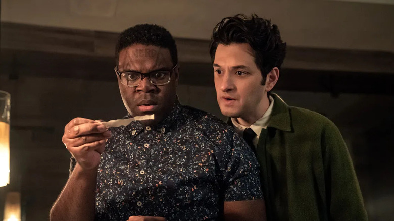 Aniq and Yasper looking at a clue on The Afterparty