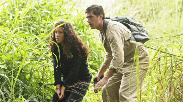 Kate and Jack crouching in jungle in "Lost"