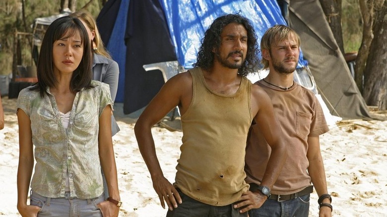 Sun, Sayid, and Charlie standing on the beach in "Lost."