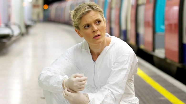 Nikki investigating at a metro station in protective coveralls in Silent Witness (1996)