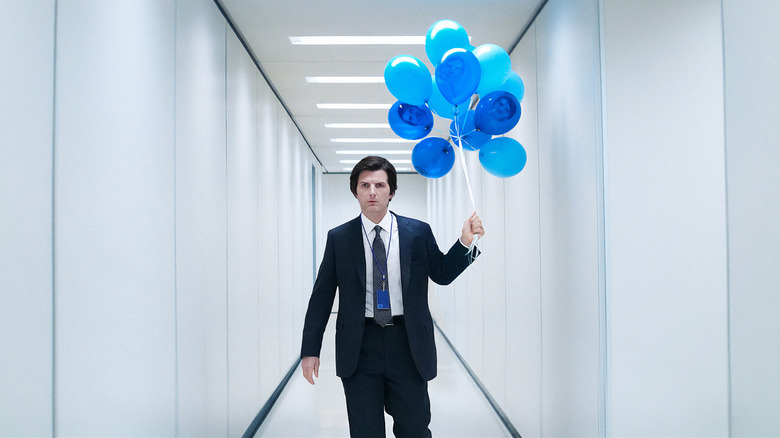 Mark walks down a corridor holding a dozen blue balloons in Severance (2022-)