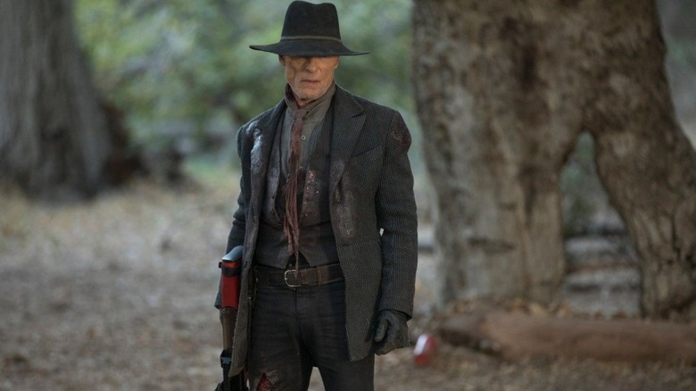 The man in black stands in a clearing in the woods in Westworld (2016-2022)