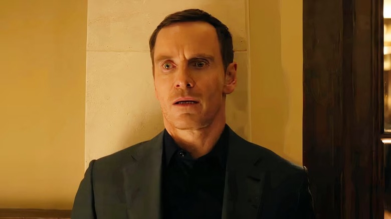 Brandon Colby looks worried as he leans against a wall.