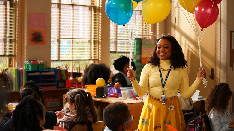 Janine holding balloons in her classroom on Abbott Elementary