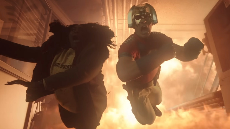 Peacemaker leaping away from explosion