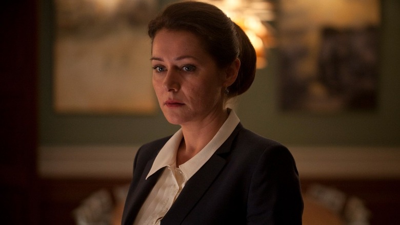 Birgitte in a suit looking concerned.