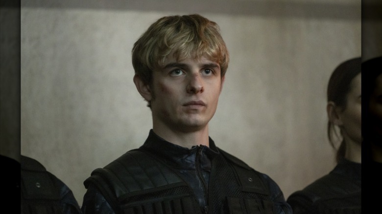 Alex standing in a line, wearing all black, in "Alex Rider."