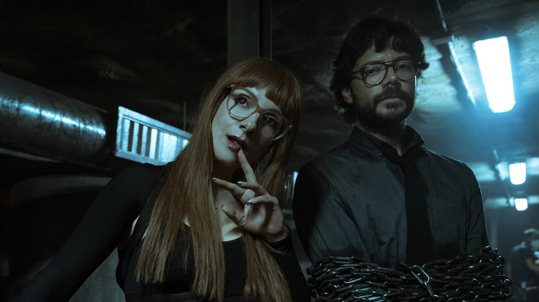 The Professor in chains and Alicia in long red wig