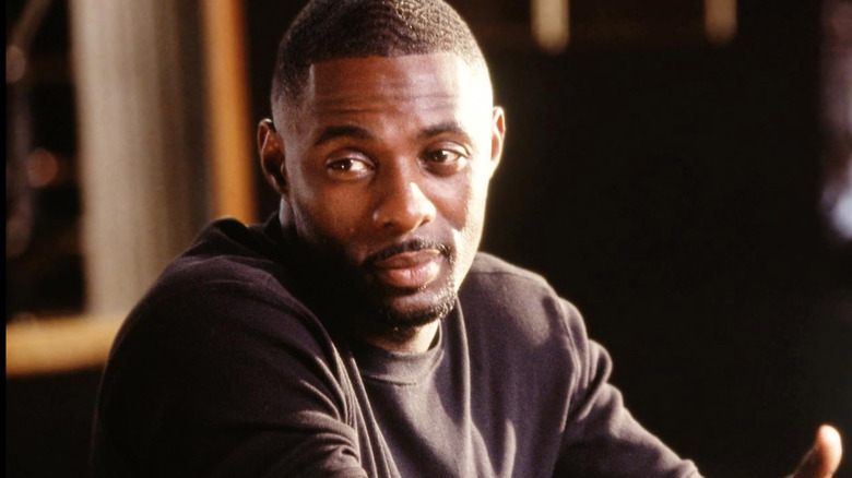Stringer Bell sitting at table shrugging