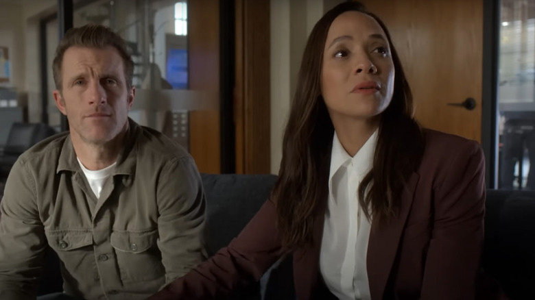 Nikki and Jason sit on a couch in an office in Alert: Missing Persons Unit