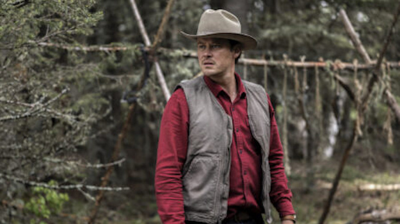 Joe Pickett stands in the woods in Joe Pickett.