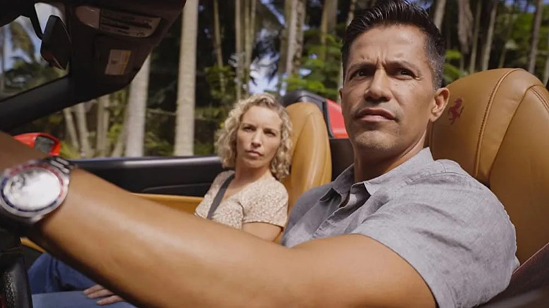 Thomas Magnum sits in his convertible in Magnum PI.