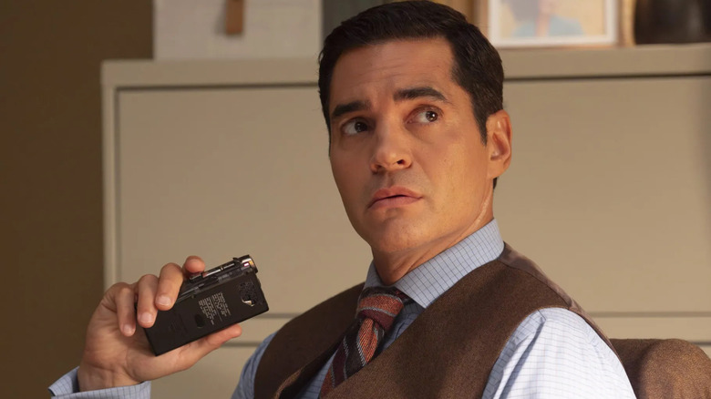 Will talks into a voice recorder and looks up from his desk in Will Trent.