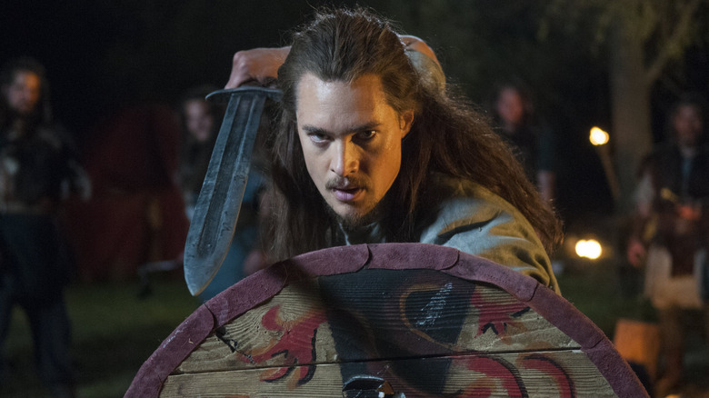 Uhtred holding up sword and shield (2015)