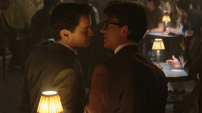 Hawk and Tim lean in to kiss at a bar in "Fellow Travelers"