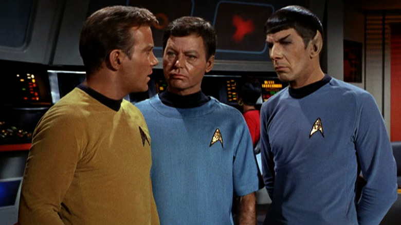 Kirk talks to McCoy and Spock aboard the Enterprise in "Star Trek"