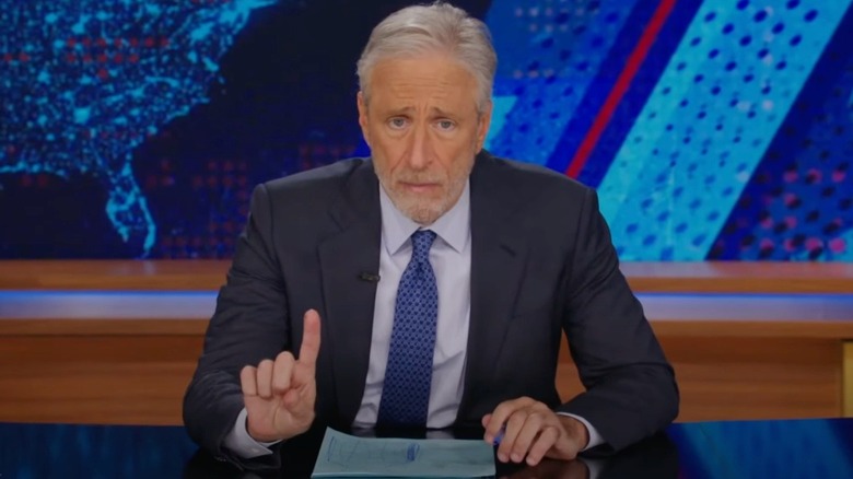 Jon Stewart sits at his desk in "The Daily Show"