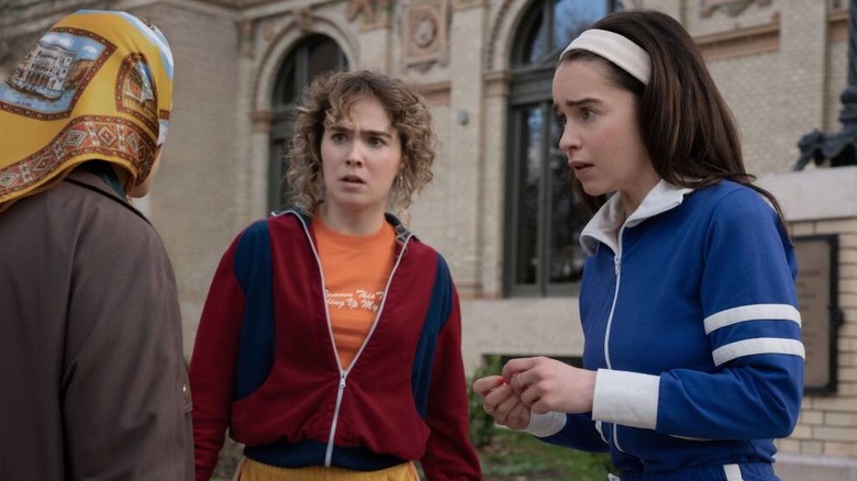 Twila and Beatrice having a serious conversation with an elderly woman in a headscarf