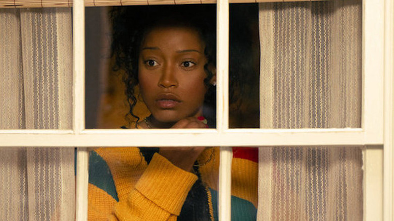 Samira looking out her classic, suburban window with an intrigued look