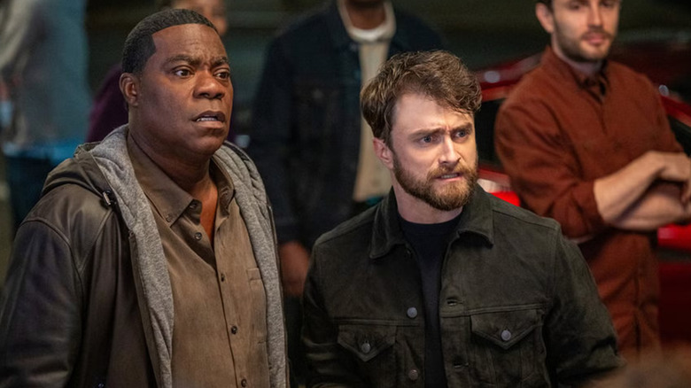 Reggie and Arthur in a nighttime crowd with matching, horrified looks on their faces