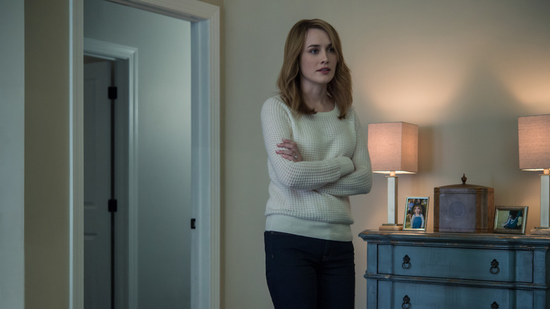 Hannah standing in room with arms crossed on House of Cards