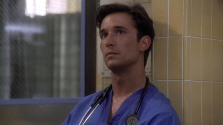 Dr. Carter leaning against a wall in ER (1994)