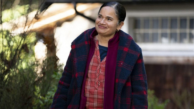 Yolanda standing outside smiling in Maid (2021)
