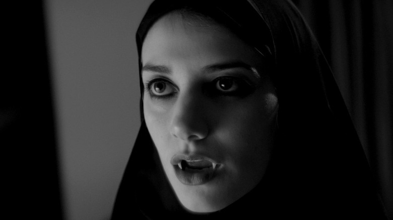 The girl shows her teeth to a bad man in "A Girl Walks Home Alone At Night"