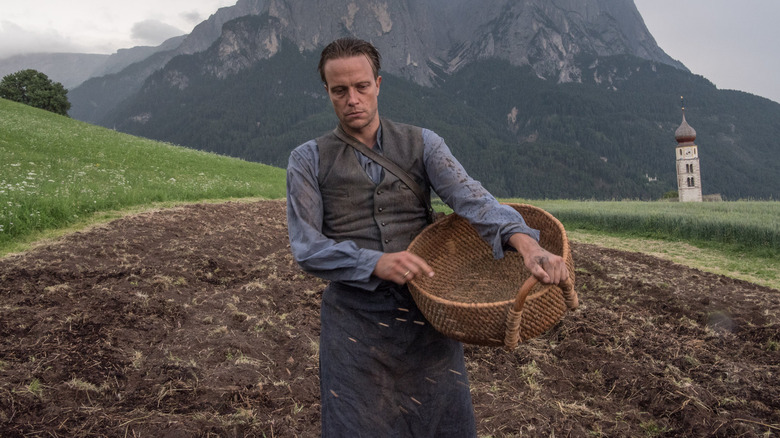 Franz Jägerstätter tending to his crops in A Hidden Life (2019)